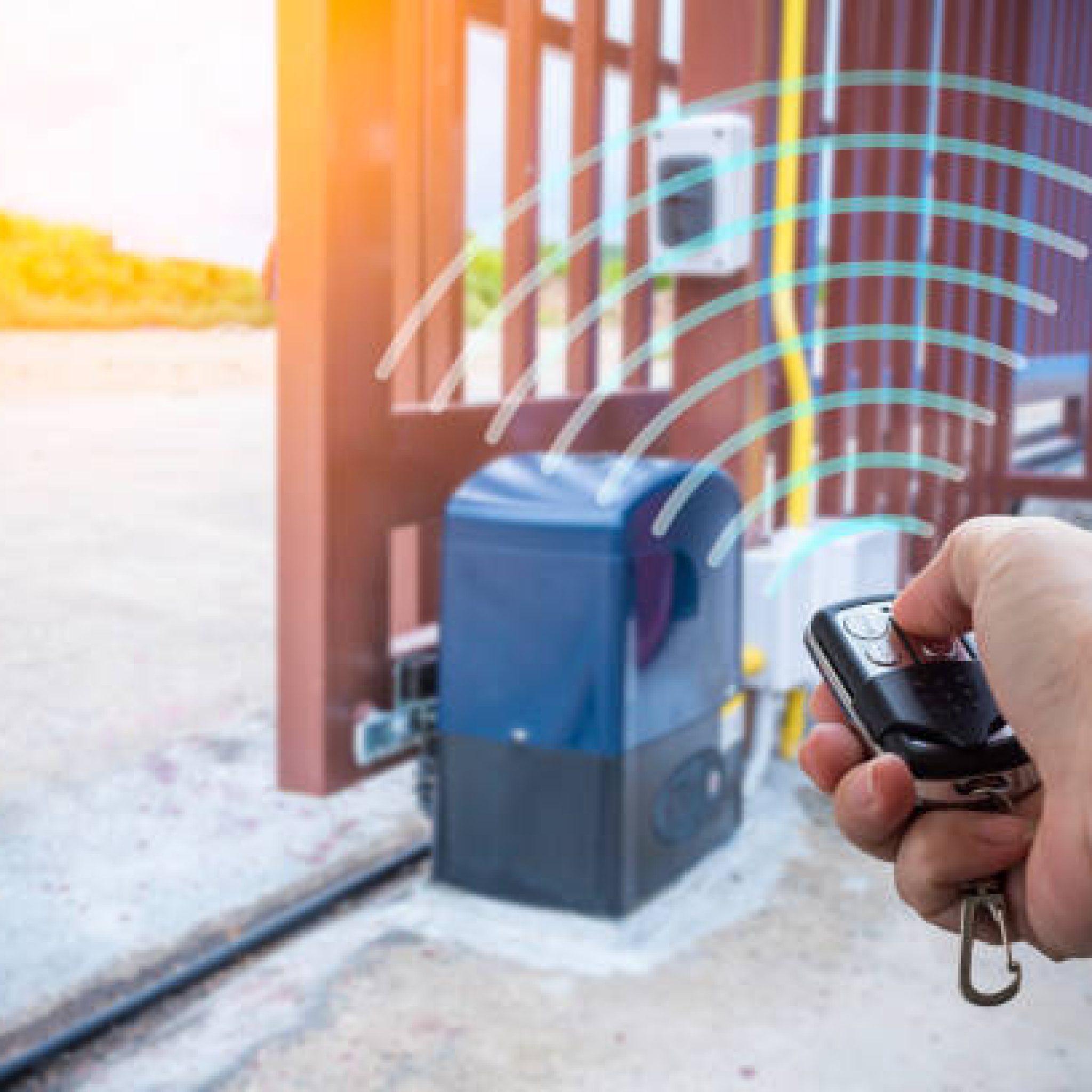 Signal of remote control when person open automatic gate at house with sunlight rays